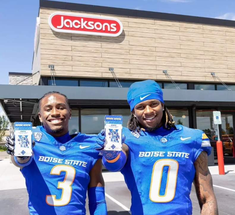 Boise State football players holding ONIT trading cards outside Jacksons